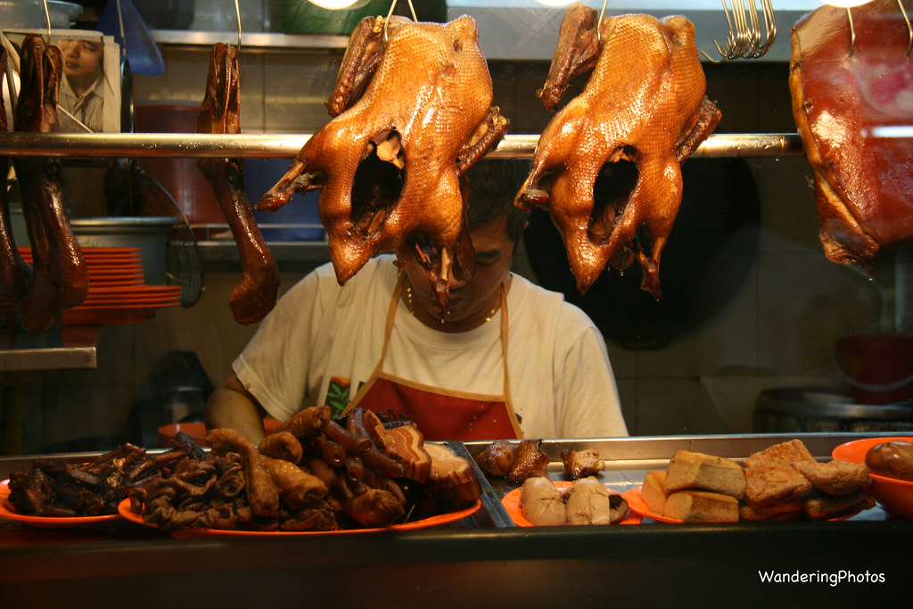 This image depicts a Hawker preparing a Singaporean delicacy that some expats might find unappealing. 