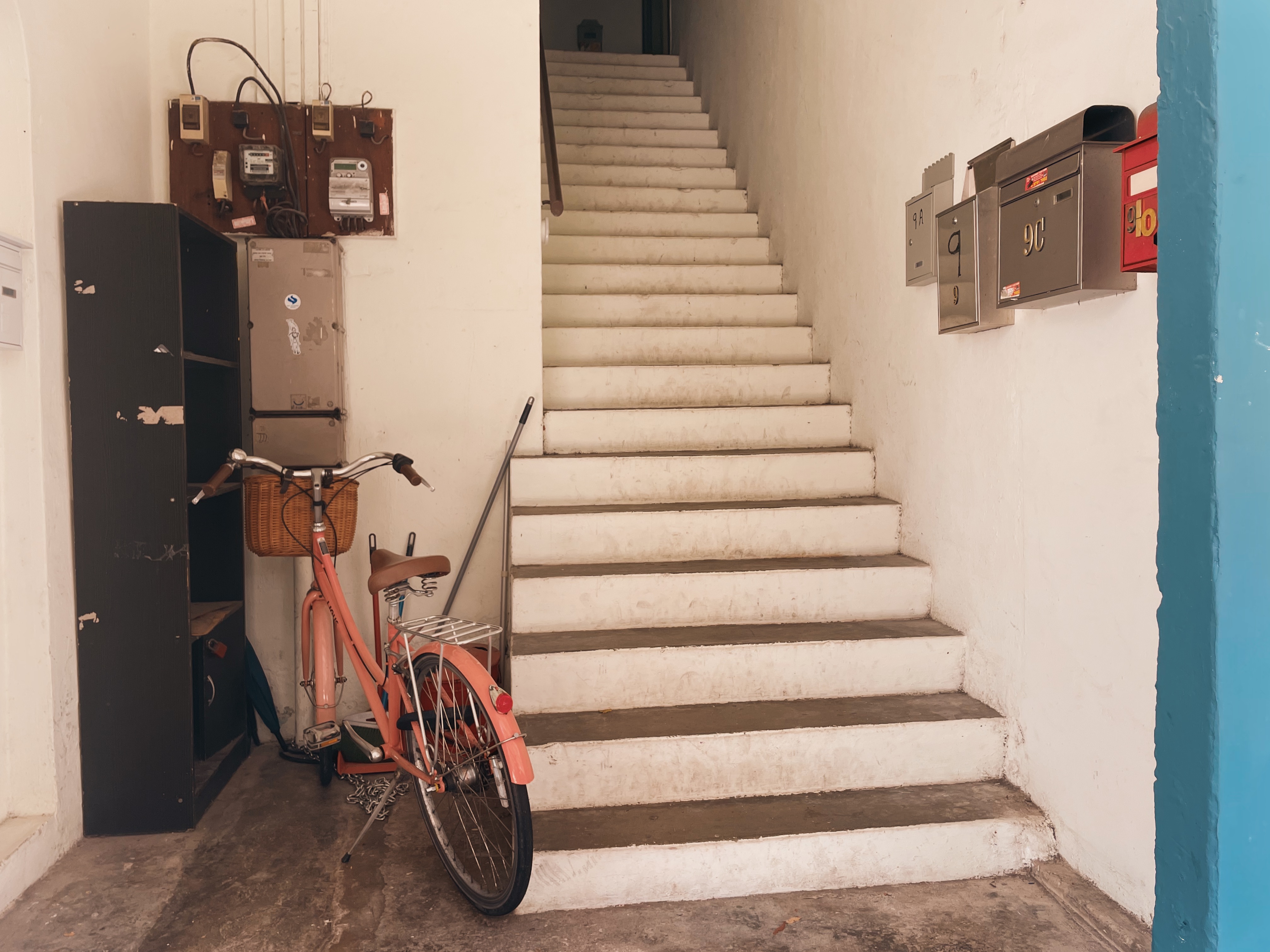 This image depicts the narrow entry way into a typical subsidised housing block in Singapore. Many expats may not enjoy living in such close quarters or in such small apartments.  