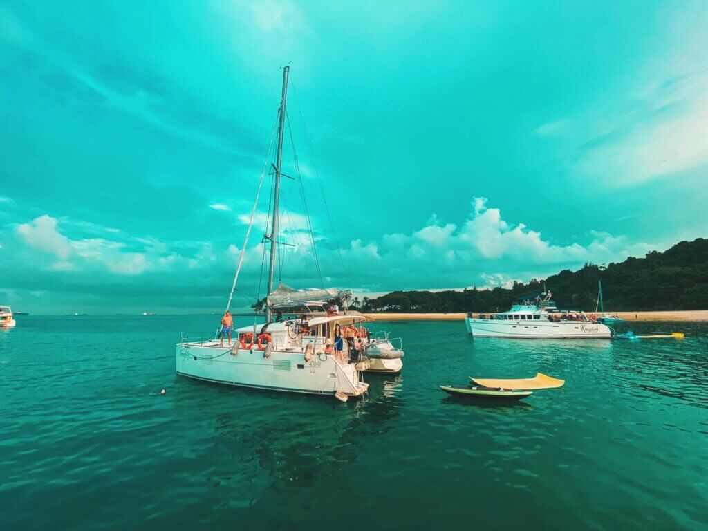 This image shows people on a yacht on a very rainy day in Singapore. 